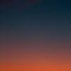Fiery sunset with crescent moon Crescent moon and fiery orange sunset horizon